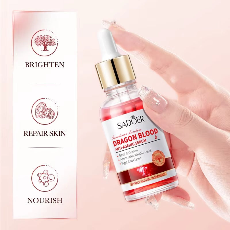 Sador Dragon Blood serum bottle held by a hand with product features on a pink background