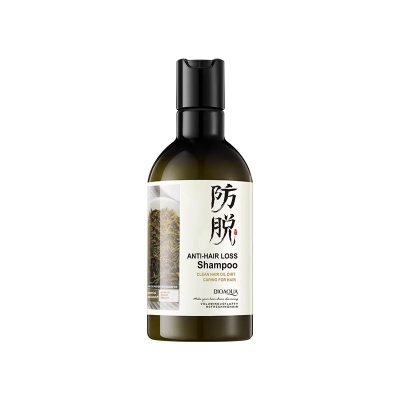 Bottle of anti-hair loss shampoo with a white label on a white background