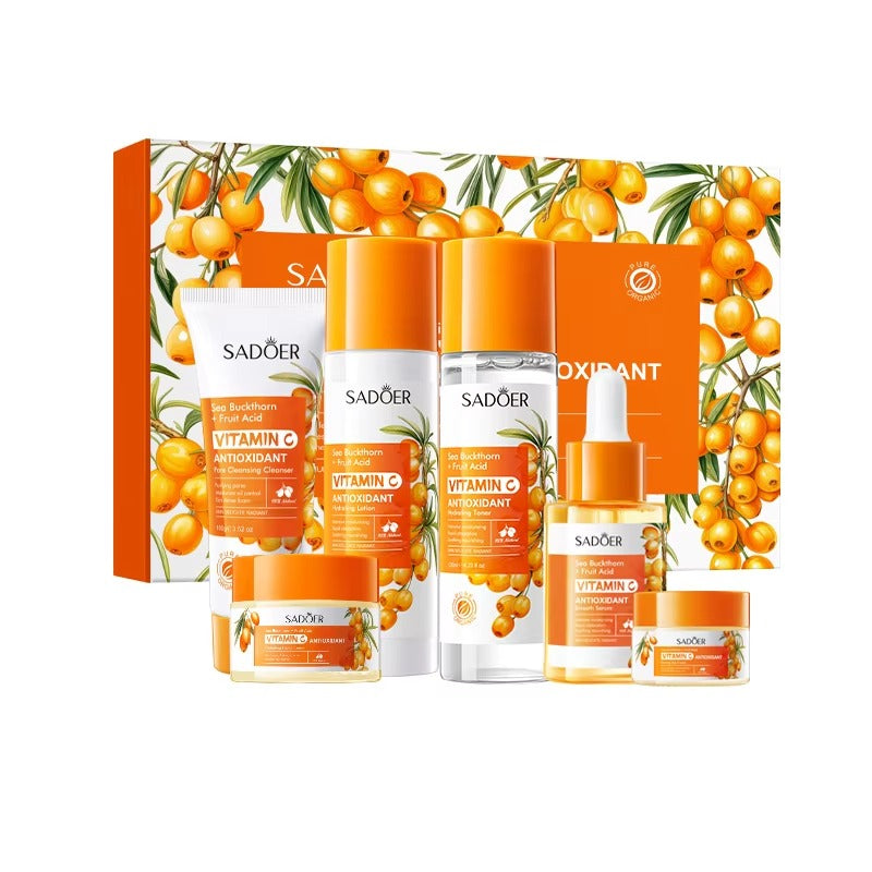 Skincare product set with orange and white packaging featuring sea buckthorn berries on a white background.